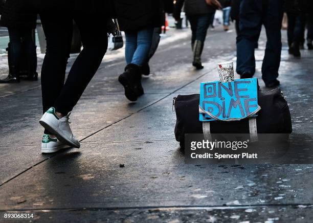 Bag of a panhandler sits on a Manhattan street on December 14, 2017 in New York City. According to a new report released by the U.S. Department of...