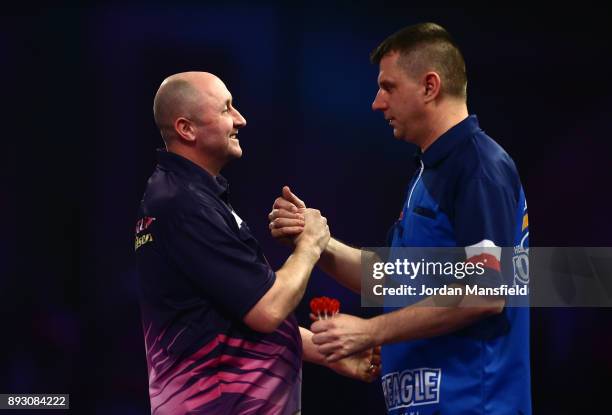 James Wilson of England shakes hands with Krzysztof Ratajski of Poland after victory in their first round match during day one of the 2018 William...