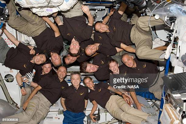 In this photo provided by NASA, A record 13 astronauts and cosmonauts assemble for a shuttle-station group photo on the orbiting outpost July 25,...