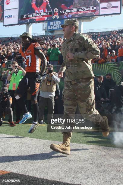 Dre Kirkpatrick of the Cncinnati Bengals takes the field with a member of the U.S. Armed Forces before the game against the Cleveland Browns at Paul...