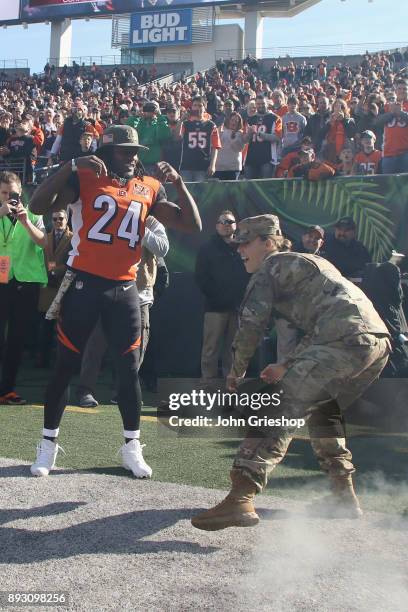 Adam Jones of the Cncinnati Bengals takes the field with a member of the U.S. Armed Forces before the game against the Cleveland Browns at Paul Brown...