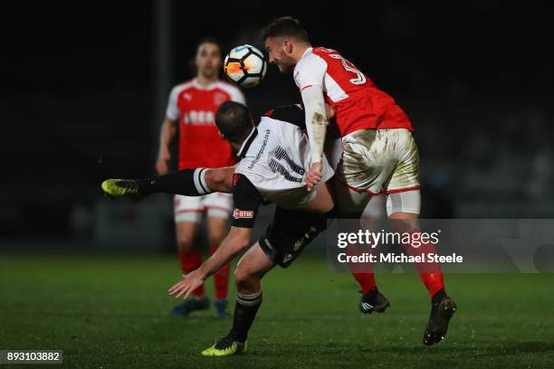 Mike Symons of Hereford is fouled by Baily Cargill of Fleetwood during the Emirates FA Cup second round replay match between Hereford FC and...