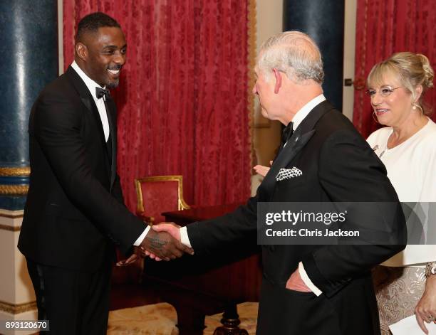 Prince Charles, Prince of Wales chats to actor Idris Elba as he hosts the 'One Million Young Lives' dinner at Buckingham Palace on December 14, 2017...