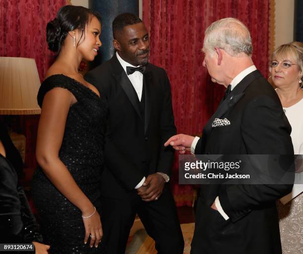Prince Charles, Prince of Wales chats to actor Idris Elba and his partner Sabrina Dhowre as he hosts the 'One Million Young Lives' dinner at...