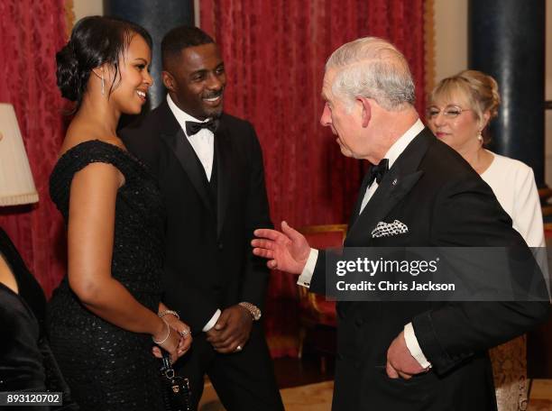 Prince Charles, Prince of Wales chats to actor Idris Elba and his partner Sabrina Dhowre as he hosts the 'One Million Young Lives' dinner at...