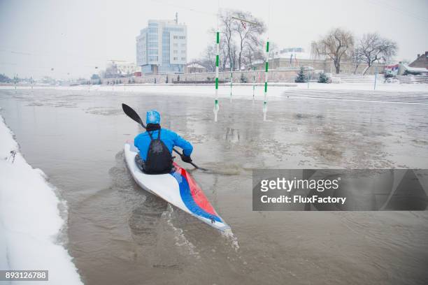 young sportsman kayaking in the cold river - serbian flag stock pictures, royalty-free photos & images