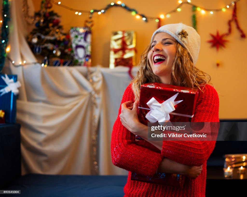 Young woman holding a Christmas present