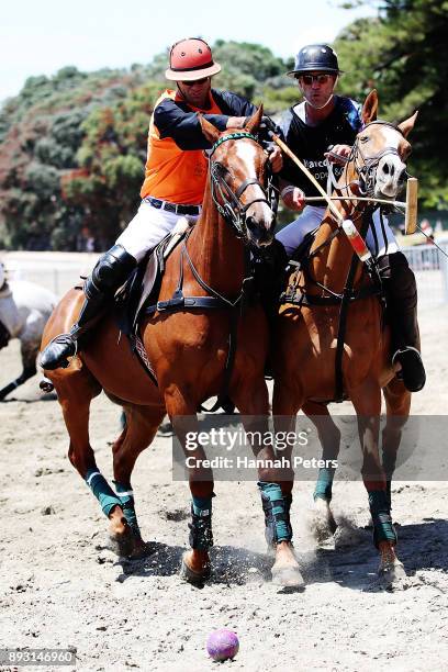 Matt Hitchman competes for the ball with Justin Watson during 2018 Takapuna Beach Polo on December 15, 2017 in Auckland, New Zealand.