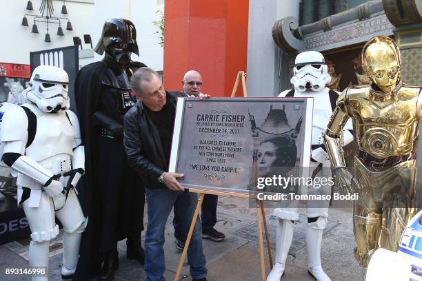 Todd Fisher unveils a commemorative plaque in honor of his sister Carrie Fisher for the opening day of "Star Wars: The Last Jedi" at TCL Chinese...