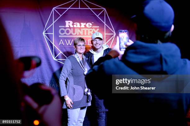 Singer-songwriter Kane Brown takes photos with fans at the Rare Country Awards on December 14, 2017 in Nashville, Tennessee.