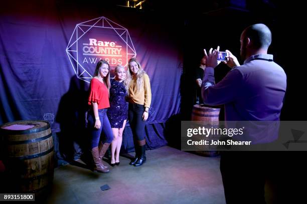 Singer-songwriter RaeLynn takes photos with fans at the Rare Country Awards on December 14, 2017 in Nashville, Tennessee.