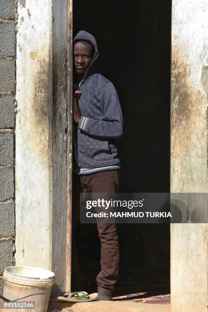 An African migrant looks towards the camera at a Safe House in the town of Bani Walid, on the edge of the desert 170 kilometres southeast of the...