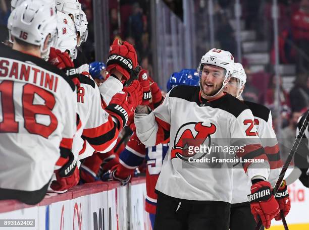 Stefan Noesen of the New Jersey Devils celebrates with the bench after scoring a goal against the Montreal Canadiens in the NHL game at the Bell...