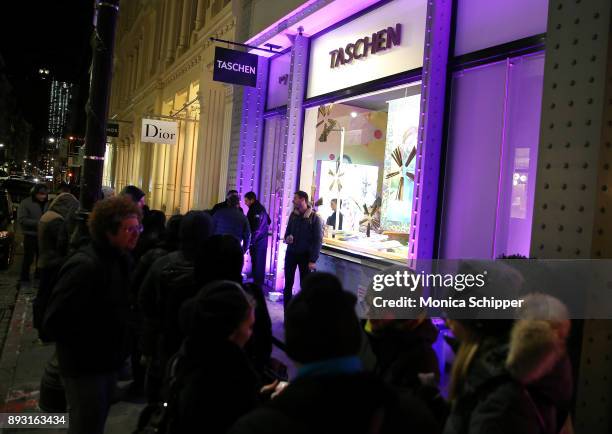 Guests wait in line outside TASCHEN as photographer David LaChapelle signs copies of his new double-volume book "Good News Part I" And "Lost + Found...