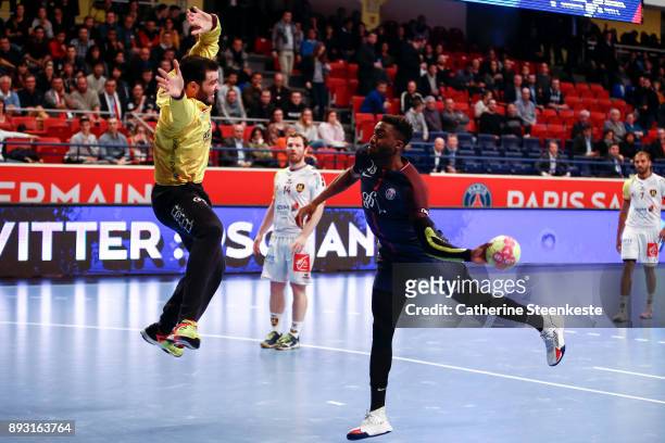Luc Abalo of Paris Saint Germain is shooting the ball against Cyril Dumoulin of HBC Nantes during the Coupe de la Ligue Quarter Final match between...