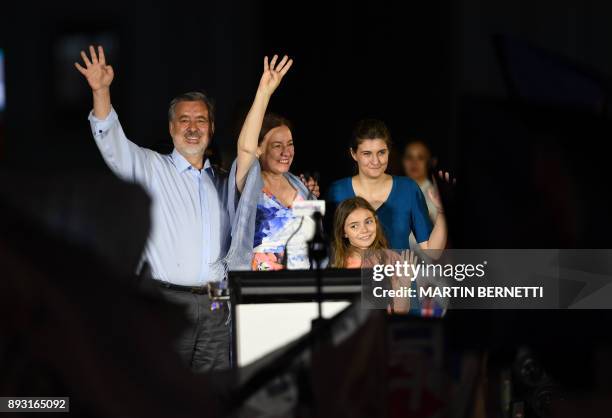 The Chilean presidential candidate for the ruling New Majority coalition, Alejandro Guillier , waves to supporters next to his family after giving a...