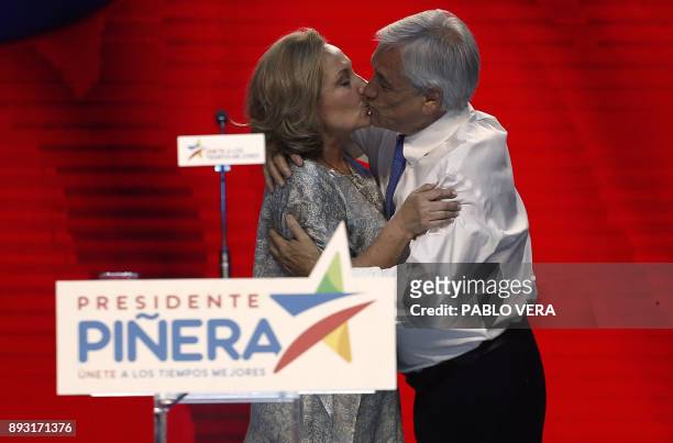 Chilean presidential candidate Sebastian Pinera kisses his wife Cecilia Morel during his final election campaign rally in Santiago, on December 14,...