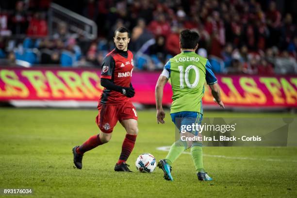 Sebastian Giovinco of Toronto FC looks for the open man against Nicolas Lodeiro of Seattle Sounders during the 2017 Audi MLS Championship Cup match...