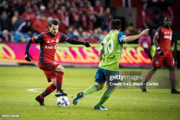 Sebastian Giovinco of Toronto FC tries to break away from Nicolas Lodeiro of Seattle Sounders during the 2017 Audi MLS Championship Cup match between...