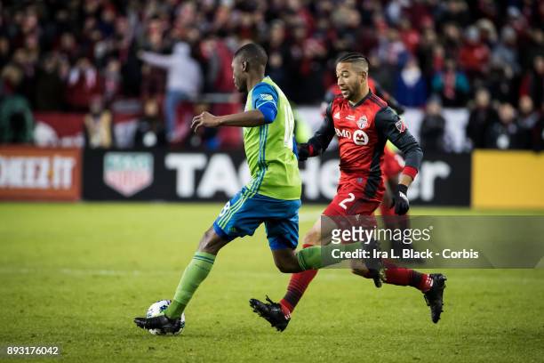 Kelvin Leerdam of Seattle Sounders tries to clear the ball from Justin Morrow of Toronto FC during the 2017 Audi MLS Championship Cup match between...