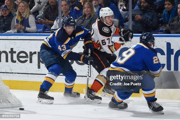 Jordan Schmaltz of the St. Louis Blues defends against Rickard Rakell of the Anaheim Ducks as he makes a pass at Scottrade Center on December 14,...