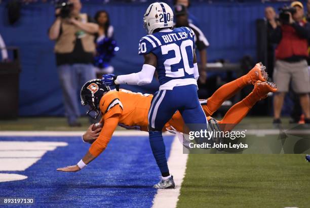 Denver Broncos quarterback Brock Osweiler dives in to the end zone as Indianapolis Colts free safety Darius Butler looks on during the second quarter...