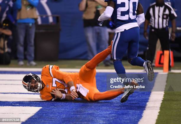 Denver Broncos quarterback Brock Osweiler dives in to the end zone as Indianapolis Colts free safety Darius Butler looks on during the second quarter...