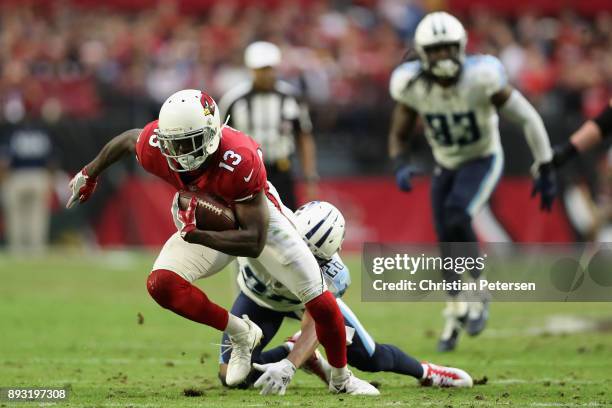 Wide receiver Jaron Brown of the Arizona Cardinals runs with the football ahead of cornerback Logan Ryan of the Tennessee Titans during the NFL game...