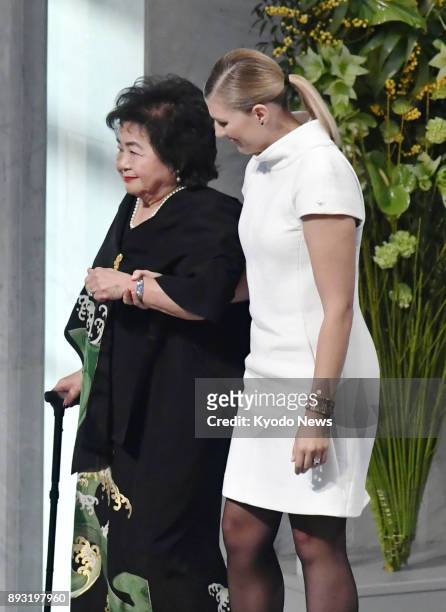 Hiroshima atomic bombing survivor Setsuko Thurlow walks with the help of Beatrice Fihn, head of the International Campaign to Abolish Nuclear...