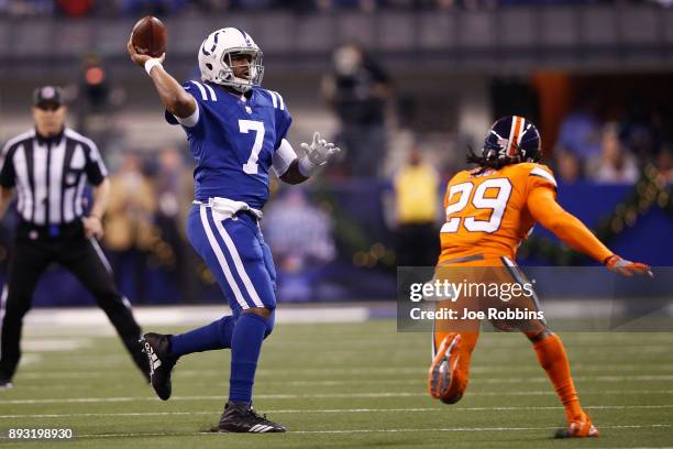 Jacoby Brissett of the Indianapolis Colts throws a pass under pressure from Bradley Roby of the Denver Broncos during the first half at Lucas Oil...