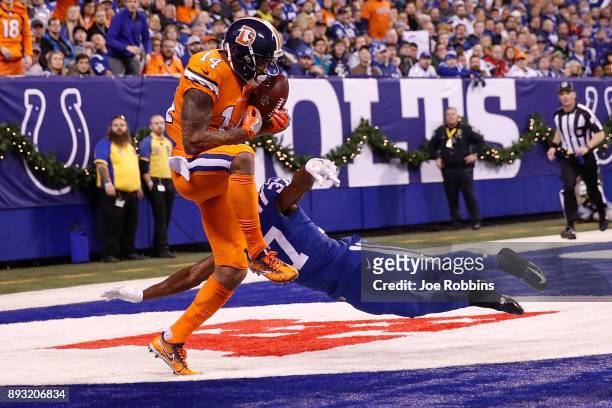 Cody Latimer of the Denver Broncos makes a catch for a touchdown defended by D.J. White of the Indianapolis Colts during the second half at Lucas Oil...