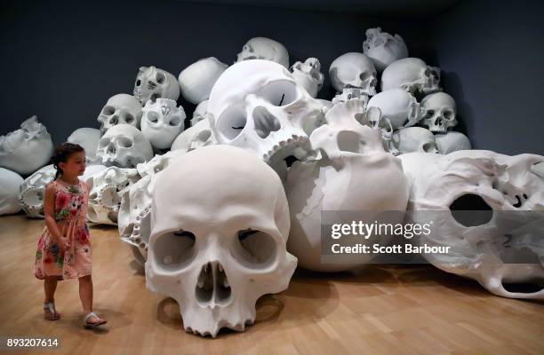 Child walks through artist Ron Mueck's world-premiere installation 'Mass', consisting of 100 larger-than-life skulls each measuring 1.5m x 2m during...