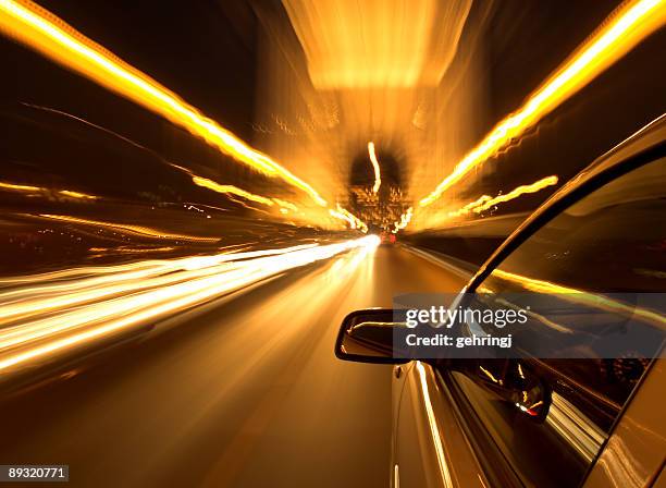 selective focus photo of car driving at night - röra mot bildbanksfoton och bilder
