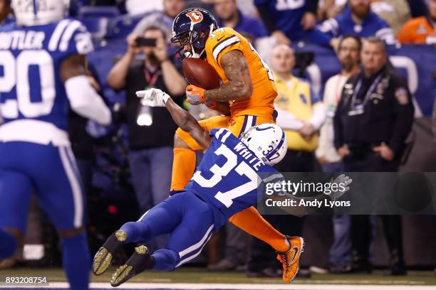 Cody Latimer of the Denver Broncos makes a catch for a touchdown defended by D.J. White of the Indianapolis Colts during the second half at Lucas Oil...