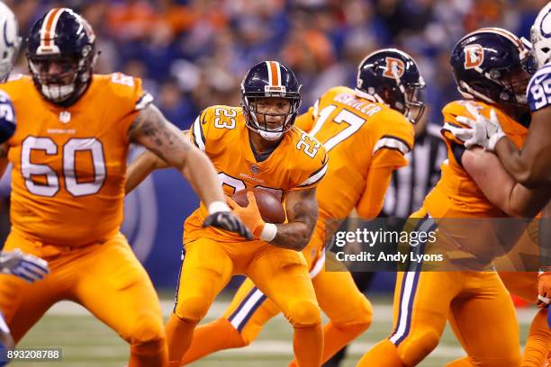 Devontae Booker of the Denver Broncos runs with the ball against the Indianapolis Colts during the second half at Lucas Oil Stadium on December 14,...