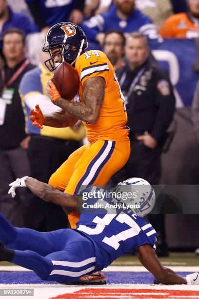 Cody Latimer of the Denver Broncos makes a catch for a touchdown defended by D.J. White of the Indianapolis Colts during the second half at Lucas Oil...