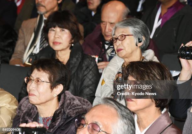 Tomiko Fukushima , a survivor of the 1945 U.S. Atomic bombing in Nagasaki, watches a broadcast of the Nobel Peace Prize award ceremony at a public...