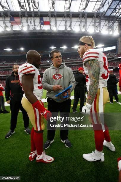 Elvis Dumervil, Defensive Line Coach Jeff Zgonina and Cassius Marsh of the San Francisco 49ers talk on the sideline during the game against the...