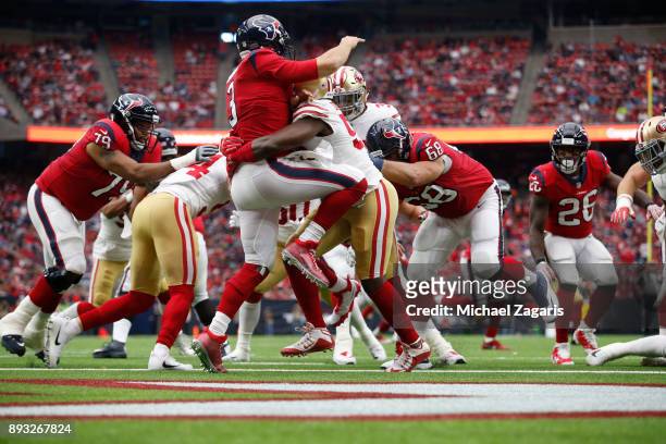 Elvis Dumervil of the San Francisco 49ers hits Tom Savage of the Houston Texans during the game at NRG Stadium on December 10, 2017 in Houston,...