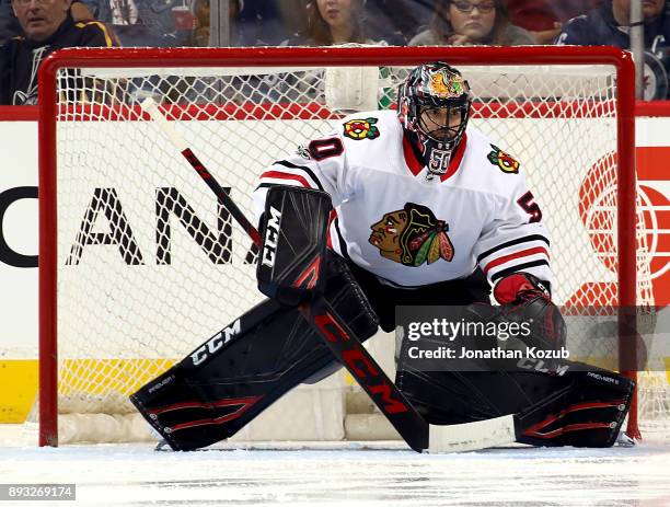 Goaltender Corey Crawford of the Chicago Blackhawks guards the net during third period action against the Winnipeg Jets at the Bell MTS Place on...