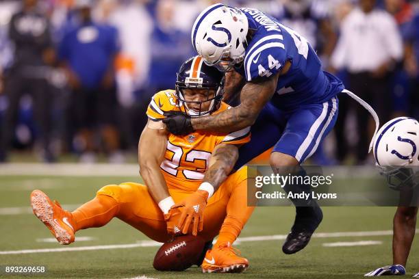 Devontae Booker of the Denver Broncos drops a pass defended by Antonio Morrison of the Indianapolis Colts during the second half at Lucas Oil Stadium...