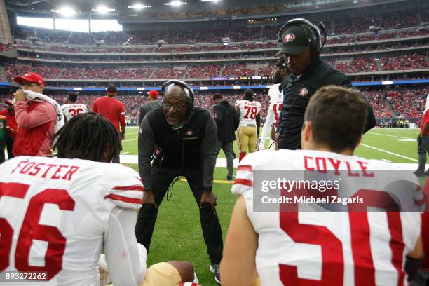 Linebackers Coach Johnny Holland of the San Francisco 49ers talks with Reuben Foster and Brock Coyle on the sideline during the game against the...