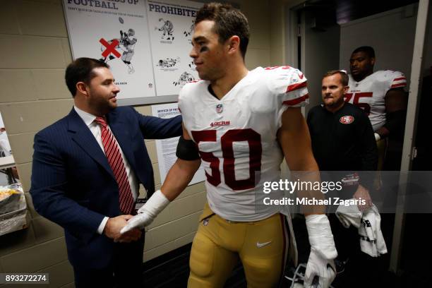 Jed York of the San Francisco 49ers greets Brock Coyle at the locker room following the game against the Houston Texans at NRG Stadium on December...