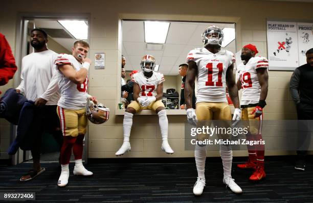 Trent Taylor, Victor Bolden Jr. #17, Marquise Goodwin and Aldrick Robinson of the San Francisco 49ers relax in the locker room prior to the game...