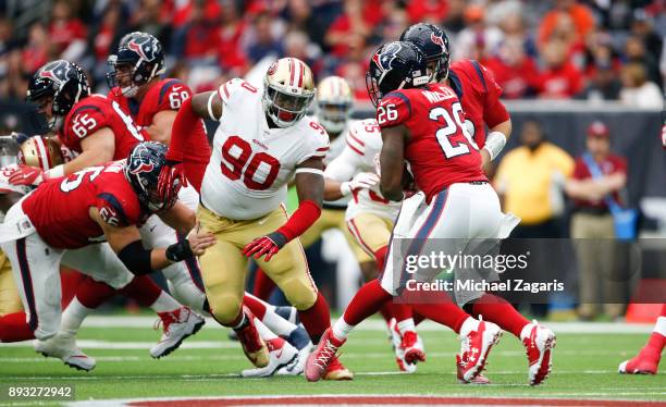 Earl Mitchell of the San Francisco 49ers closes in on Lamar Miller of the Houston Texans during the game at NRG Stadium on December 10, 2017 in...