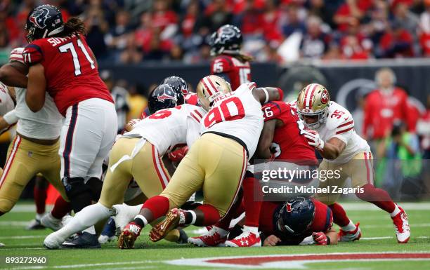 Earl Mitchell of the San Francisco 49ers tackles Lamar Miller of the Houston Texans during the game at NRG Stadium on December 10, 2017 in Houston,...