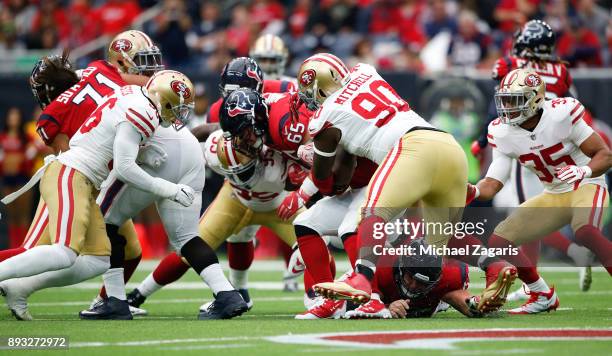 Earl Mitchell of the San Francisco 49ers tackles Lamar Miller of the Houston Texans during the game at NRG Stadium on December 10, 2017 in Houston,...