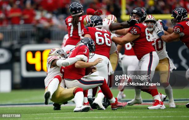 Eli Harold of the San Francisco 49ers sacks Tom Savage of the Houston Texans during the game at NRG Stadium on December 10, 2017 in Houston, Texas....