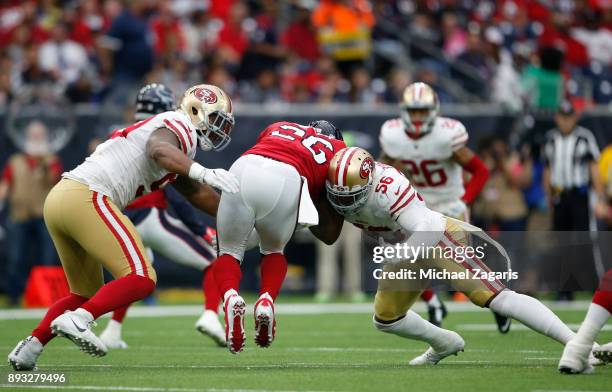 Reuben Foster and DeForest Buckner of the San Francisco 49ers tackle Lamar Miller of the Houston Texans during the game at NRG Stadium on December...