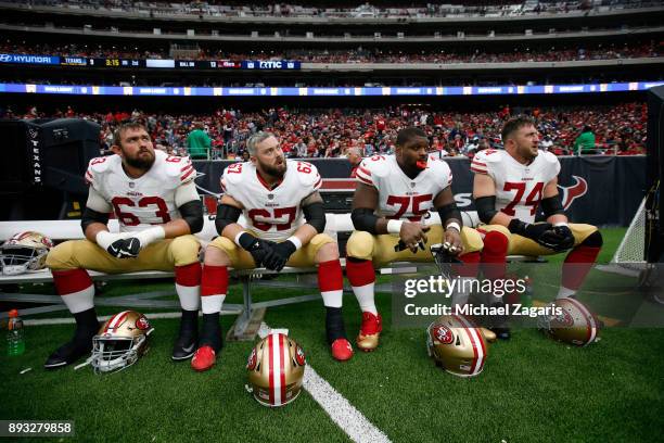Brandon Fusco, Daniel Kilgore, Laken Tomlinson and Joe Staley of the San Francisco 49ers sit on the bench during the game against the Houston Texans...